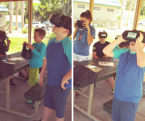 Student use virtual reality goggles to get a close up look at the progress of the project