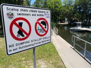 This image on Walker on the Water depicts a sign that warns visitors against dumping scallop shells in Crystal River.